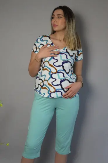 Pyjama satin coloré, top à motifs fluides et pantalon mint pour une tenue d'intérieur élégante et confortable.