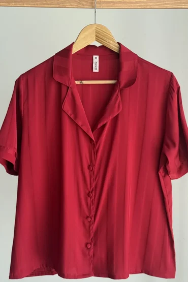 Pyjama satin rouge luxueux avec col, boutons et manches courtes, parfait pour une tenue d'intérieur élégante.
