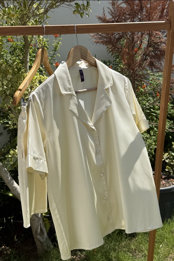 Pyjama satin jaune clair, coupe chic et confortable, idéal pour une tenue d'intérieur élégante et relaxante.