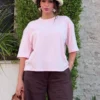 noom-pink-solid-lounge-tee-oversized-fullbody Pyjama en satin rose doux avec un style décontracté, idéal pour une tenue d'intérieur élégante et confortable.