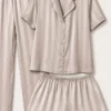 Ensemble de pyjama en satin beige à rayures, élégant et confortable, parfait pour une tenue d'intérieur luxueuse.
